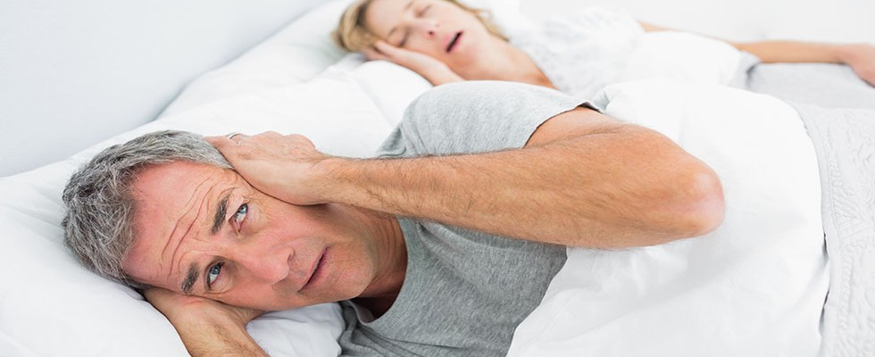 snoring woman keeping partner awake