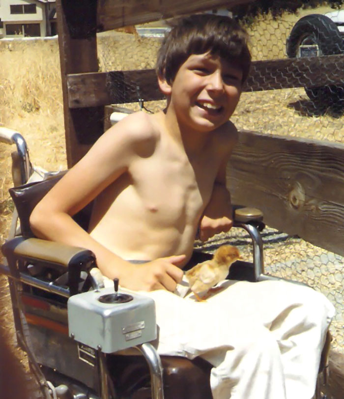 The author in an early-model power wheelchair that gave him the gift of mobility.