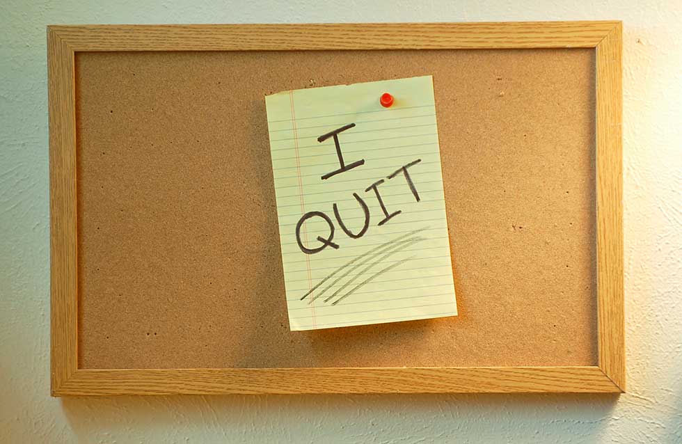 bulletin board showing legal paper with "I QUIT" written on it