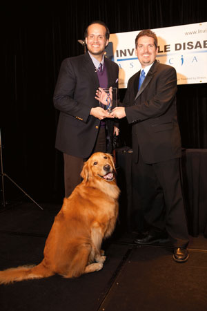 Luis Carlos Montalván—being presented with the 2011 Invisible Hero Award—with dog Tuesday and Connell