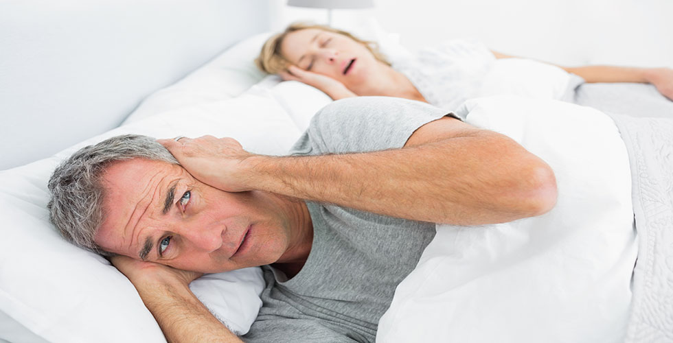 snoring woman keeping partner awake