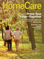 The September cover of HomeCare Magazine with an elderly woman walking arm in arm with her caregiver through the park