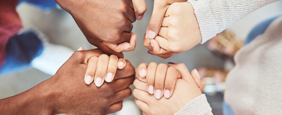 An image of two people holding hands