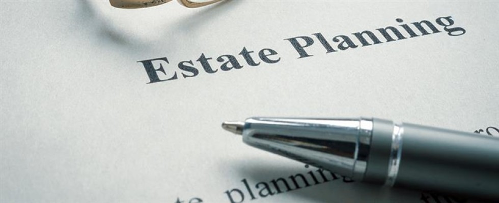 An image of paper with "Estate Planning" printed as the header and a pen 