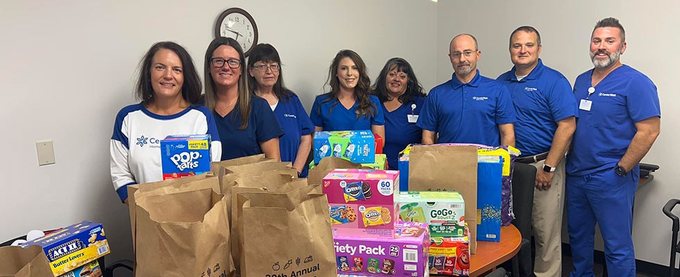 CenterWell team with food donations raised during their annual food drive.