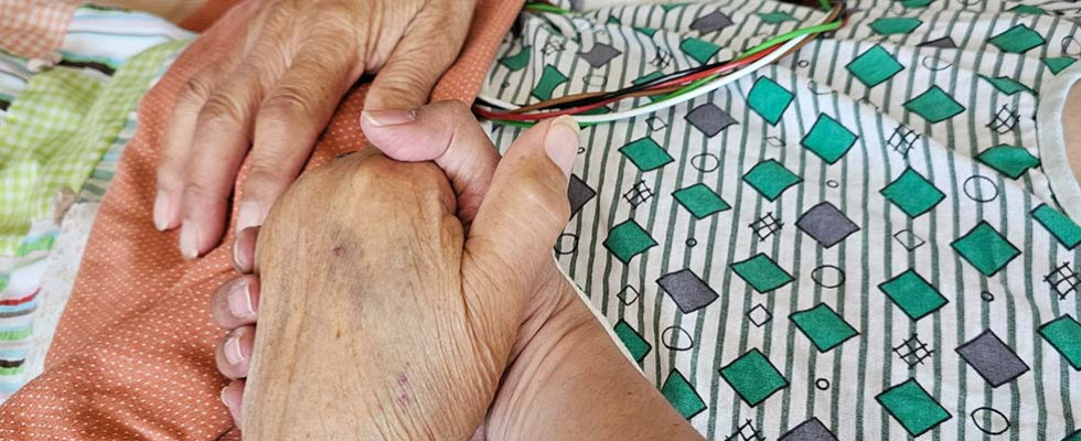 Oralia Terrazas holding her mother's hand.