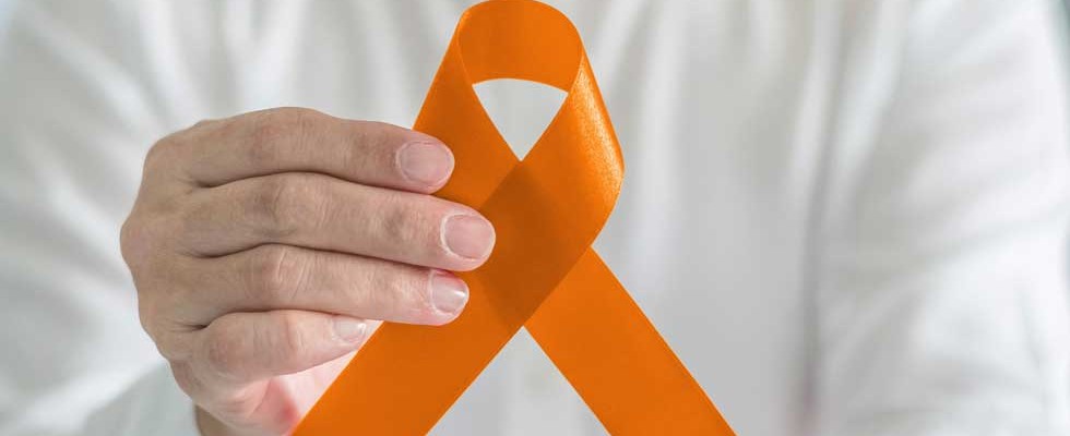 hand holding orange ribbon for COPD awareness