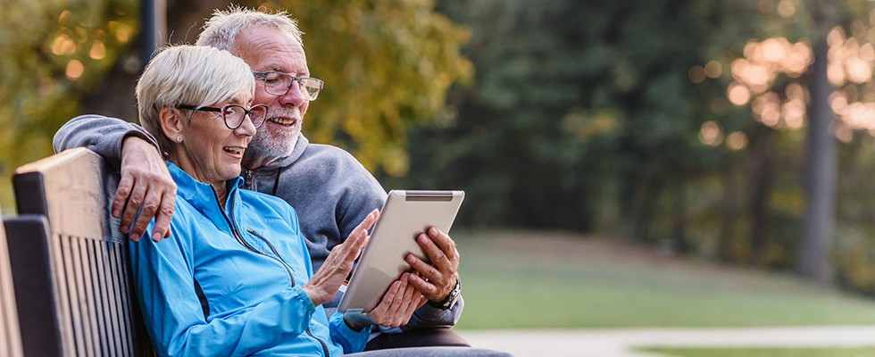 Senior man and woman looking at tablet