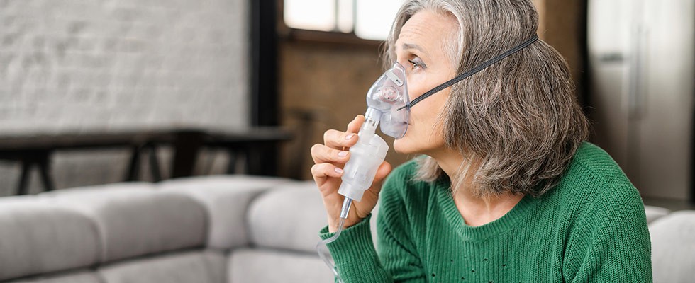 An image of an older woman with an oxygen mask on.