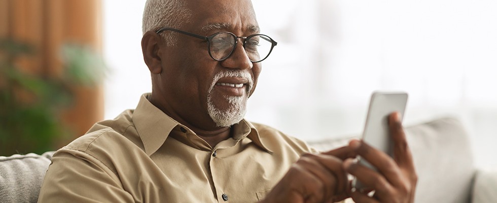 older Black man using a smartphone
