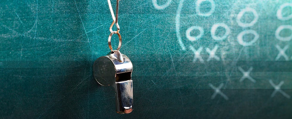 metal whistle hanging from a blackboard
