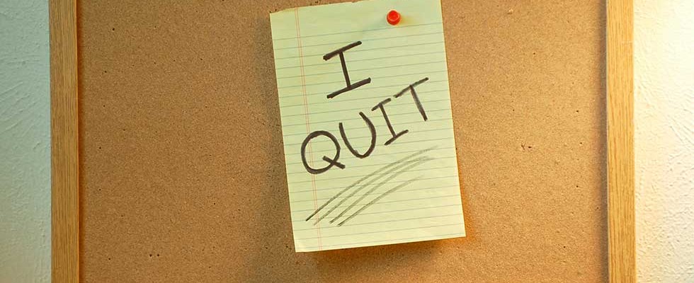 bulletin board showing legal paper with "I QUIT" written on it