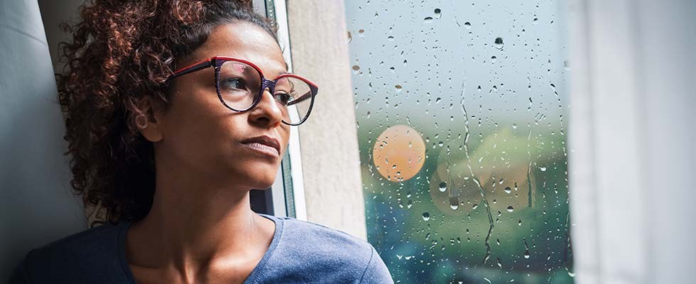 Black woman staring out window