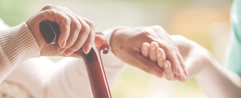 Elderly and young hands together