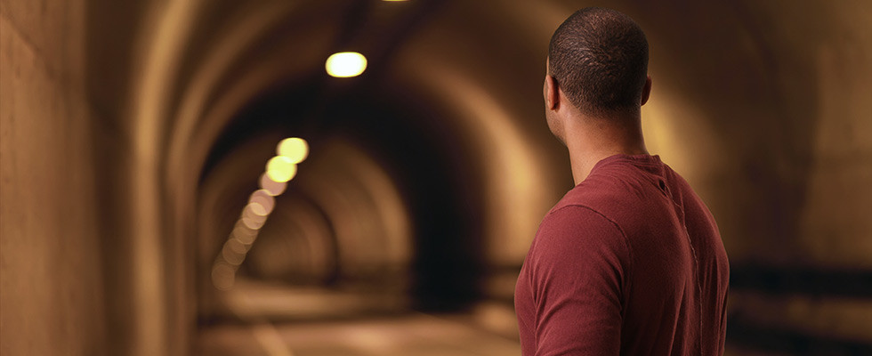 A man looking down a tunnel