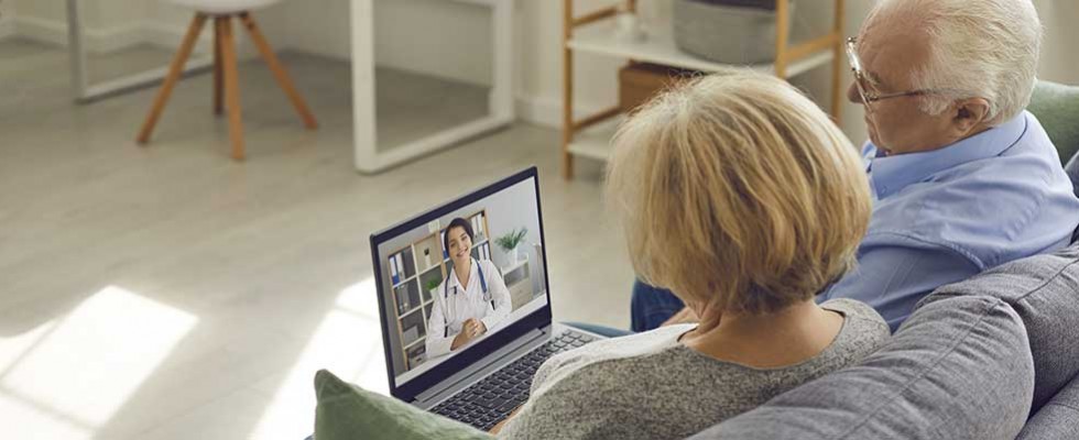 senior couple chatting with doctor on computer