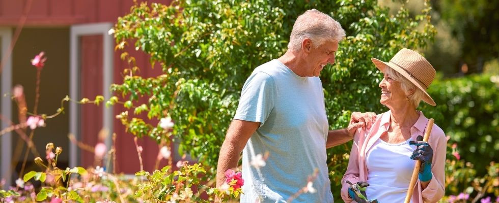 a senior couple enjoys time in a garden