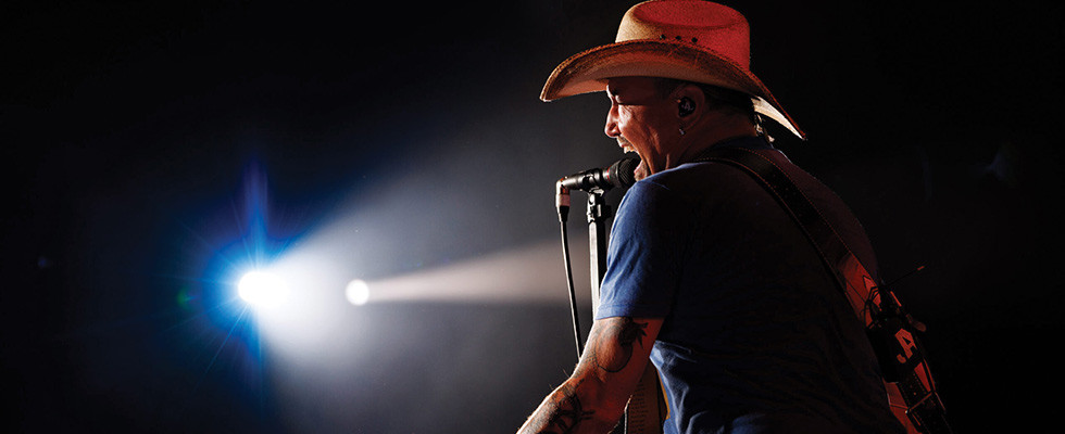 Country singer Jason Aldean singing into a microphone
