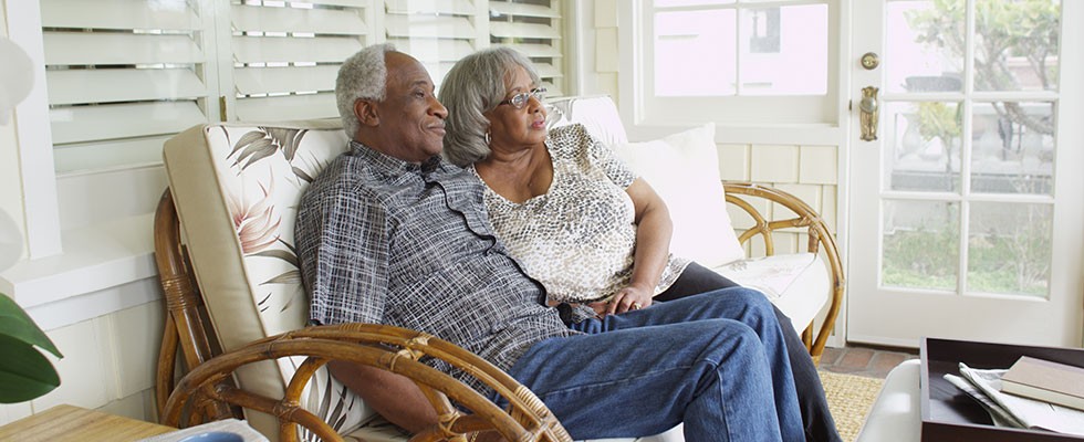 older Black couple relaxing on a porch