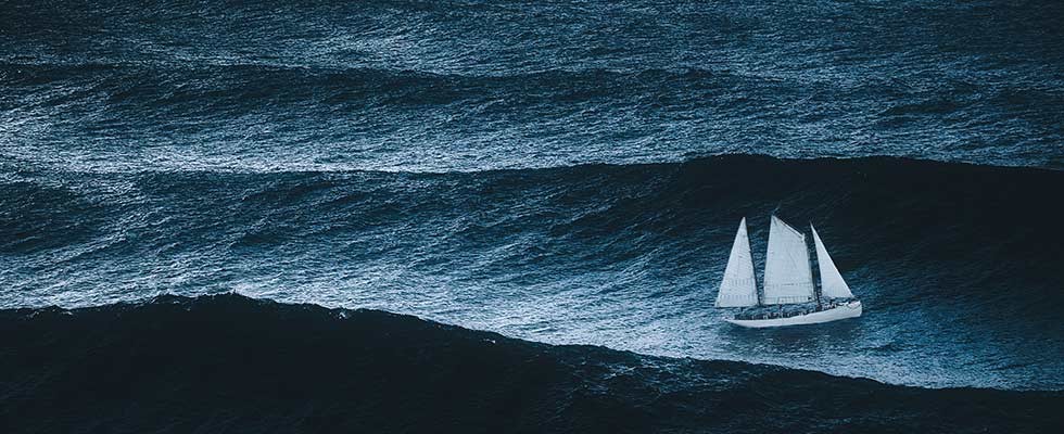 A sailboat out on choppy waves