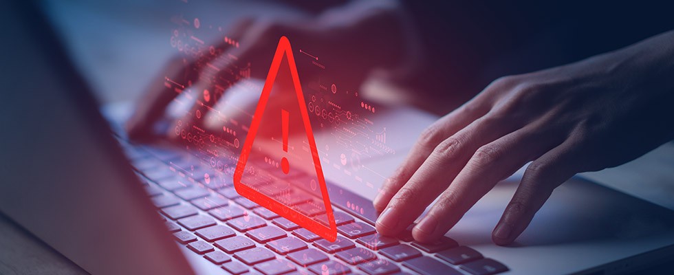 Hands at a keyboard with a large red triangle and exclamation point above it