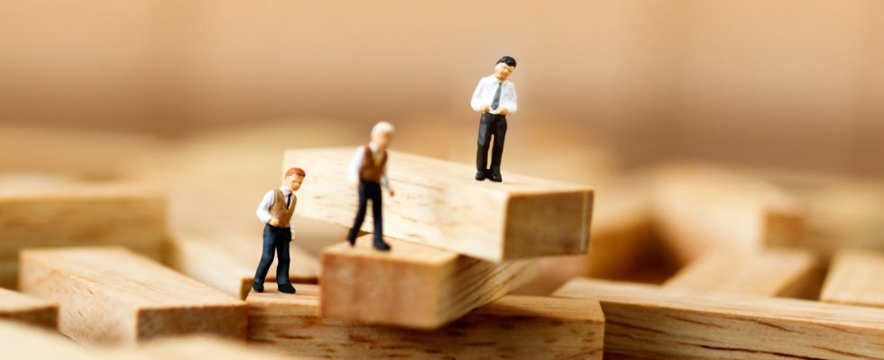 Toy business men on building blocks