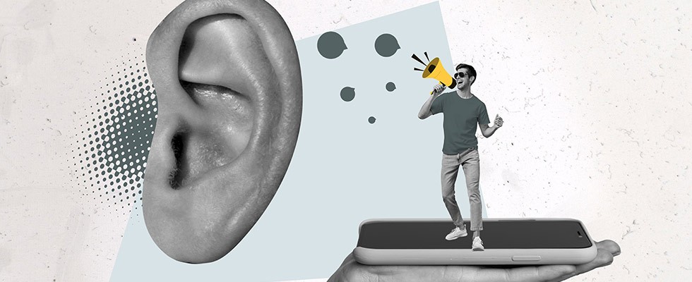 A graphic of someone standing on an iPhone speaking into a large ear
