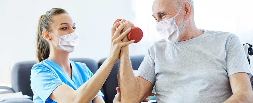 senior man receiving physical therapy