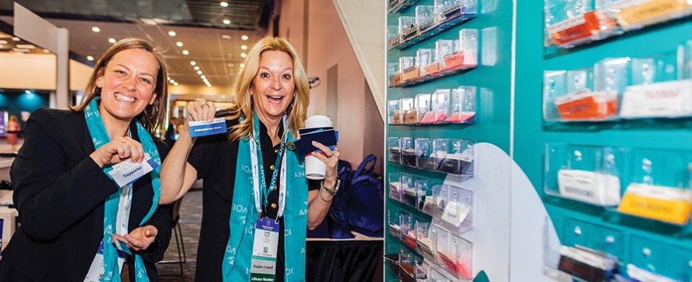 Two women holding up ribbons from the National Alliance for Care at Home Conference & Expo