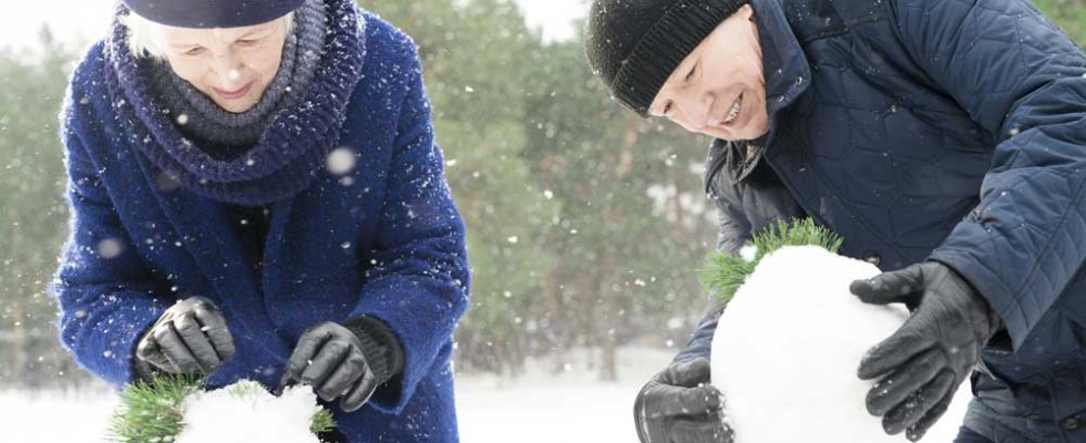 seniors building a snowman