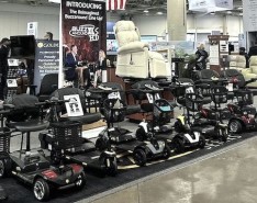An image of mobility products lined up under a Golden sign at Medtrade 2024