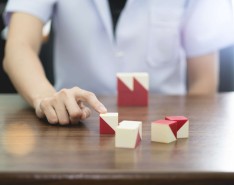 Person with finger on building blocks