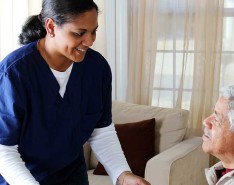 brown woman caregiver with brown senior man