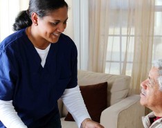 brown woman caregiver with brown senior man