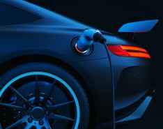 An image of a dark electric car being charged