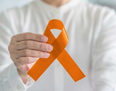 hand holding orange ribbon for COPD awareness