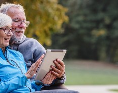 Senior man and woman looking at tablet