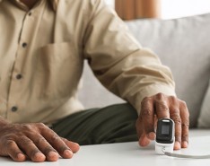 Black man checks oxygen levels using spirometer