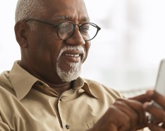 older Black man using a smartphone