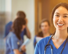 A nurse smiles at the camera