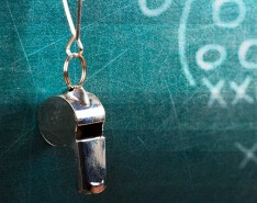 metal whistle hanging from a blackboard