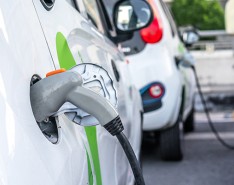 white crossover vehicles plugged in to chargers