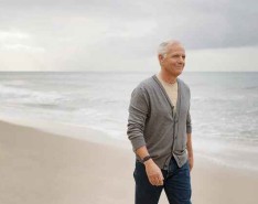 Elderly man walking on beach