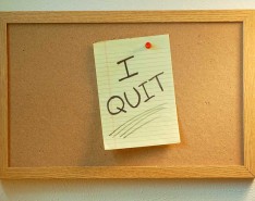 bulletin board showing legal paper with "I QUIT" written on it