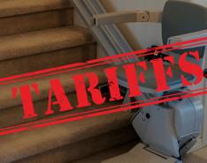 A lift-chair at the base of some stairs with a large stamp that says "TARIFFS" in the forefront.