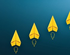 five yellow paper airplanes on a blue background. under each paper airplane their our illustrations of fire as if they are "taking off" 
