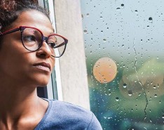 Black woman staring out window