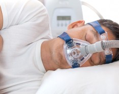man sleeping with CPAP mask on face