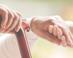 Elderly and young hands together