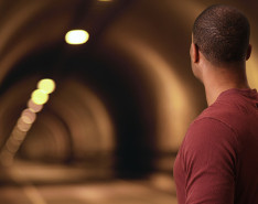A man looking down a tunnel